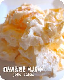 orange fluff jello salad on a white plate with the words, orange fluff jello salad