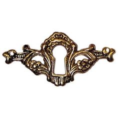 an antique brass plated drawer handle with ornate designs on the front and back side