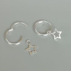 A PAIR of sterling silver hoops. Comes with a detachable tiny and delicate star charm. The charm is multipurpose and can be used with a neck or bracelet chain too. Dimension: Hoop- 12 x 1.2 mm Charm- 6 x 6 mm Weight: 0.97 gm Price listed is for a PAIR of hoops. These earrings are made of 925 hypoallergenic sterling silver and comes with a 925 stamp. Can be packaged in a gift box. I can include a personal message from you if needed You are welcome to contact me at... bhavnakwintra1956@gmail.com F Silver Charm Earrings For Everyday, Sterling Silver Huggie Earrings With Star Charm For Everyday, Silver Dangle Hoop Earrings With Charms, Small Hoop Sterling Silver Earrings With Star Charm, Silver Sterling Silver Charm Hoop Earrings, Minimalist Star-shaped Sterling Silver Huggie Earrings, Sterling Silver Star Huggie Earrings Minimalist Style, Silver Dangle Huggie Earrings With Charms, Nickel Free Star Shaped Silver Cartilage Earrings