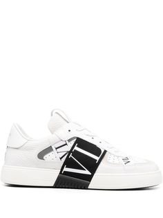 VL7N low-top sneakers from VALENTINO GARAVANI featuring white/black, calf leather, round toe, front lace-up fastening, perforated embellishment, logo-print strap, pull-tab at the tongue and flat sole. White Low-top Custom Sneakers With Embossed Logo, Custom Low-top Calf Leather Sneakers With Embossed Logo, Low-top Custom Sneakers With Embossed Logo In Calf Leather, White Calf Leather Sneakers With Embossed Logo, Designer White Calf Leather Sneakers, Designer White Sneakers With Embossed Logo, Designer Sneakers With Embossed Logo And White Sole, Designer Sneakers With White Sole And Embossed Logo, Designer Low-top Sneakers With Logo Detail