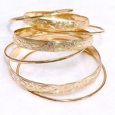 Our 7 days bangles set is make with sterling silver or 14k gold filled wire. Bangle is hand- formed, hammered into a faceted design and polished for a stunning texture and shine. It looks great worn alone or stack with other shell and charm bangles to create a chic, fun beachy look. This set come with three 8mm heirloom bangles and 4 textures bangles. Each bangle is custom made to order so can not be return or exchange for that reason. Please indicate your bangle size at checkout. If you do not Hammered Yellow Gold Bangle, Heirloom Style Bangle With Polished Finish, Big Bracelets, Custom Bangle, Ornate Jewelry, Charm Bangles, Faceted Design, Bangles Set