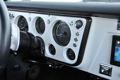 the interior of a car with buttons and gauges