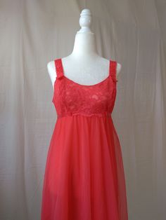 Vintage cherry red nightgown by Vanity Fair - Sheer overlay against nylon lining - Lace overlay across the bust, empire waist, and straps - Ribbon tie accent on the empire waist - Straps are not adjustable - Era: Circa 1950s - Fabric Content: 100% nylon tricot Condition: Excellent - Small mark underneath one of the straps Size: Labeled 32 - Estimated for a Medium Measurements: - 17in pit to pit - 16in empire waist - 39in length Shown on a mannequin with a 33" bust, 26" waist, and 35" hips. Fits a size 2-4. Some garments may be clipped onto mannequin or model for display. Thank you for visiting! Visit my official website, ariessencebyariel.com, for more! Sheer Coquette Dress For Wedding Night, Coquette Sheer Dress For Wedding Night, Sheer Spaghetti Strap Nightgown For Party, Sheer Spaghetti Strap Party Nightgown, Party Nightgown With Sheer Spaghetti Straps, Sheer Camisole Nightgown For Wedding Night, Sheer Sleeveless Nightgown For Party, Sheer Camisole Nightgown For Wedding, Red Spaghetti Straps Nightgown For Wedding Night