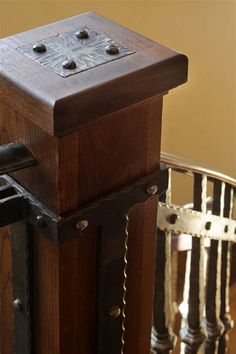 an old wooden box sitting on top of a table next to a stair case and railing