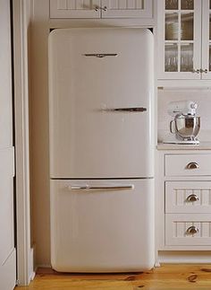 a white refrigerator freezer sitting inside of a kitchen