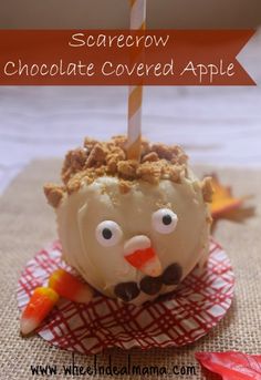 a chocolate covered apple with a candle sticking out of it's head and eyes