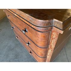 an old wooden dresser with drawers and knobs