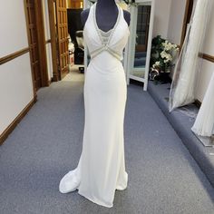 a white dress is on display in a room