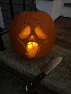 a carved pumpkin with an evil face on it