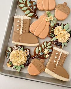 decorated cookies in the shape of boots and flowers