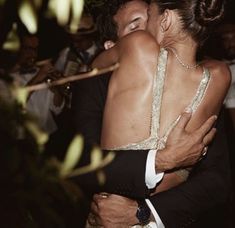 a man and woman embracing each other at a party