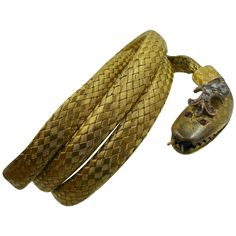 This is a very rare and wonderful antique Victorian Coiled Snake Bracelet in 14 Karat Gold with a Rose Cut Diamond crown and cabochon Ruby Eyes dating to circa 1840. A wonderful adjustable mesh design in vibrant rich yellow gold. The dramatic head of the snake is adorned with a raised Rose Cut Diamond crown. The eyes are two Ruby cabochon gems. The snake's teeth are visible through the open mouth and the forked tongue extends from the mouth. This Museum Quality jewel is magnificent. It is extrem Victorian Pendant Necklace, Coiled Snake, Victorian Pendants, Art Deco Bracelet, Diamond Crown, Snake Jewelry, Snake Bracelet, Snake Necklace, Rose Gold Bracelet