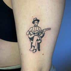 a person with a guitar tattoo on their arm