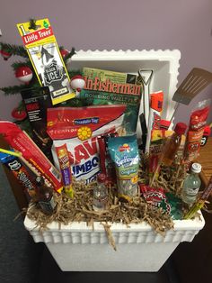 a white basket filled with food and condiments on top of a table next to a christmas tree