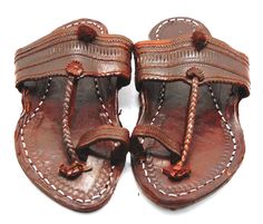 Check out our brand-new, genuine handcrafted Kolhapuri sliding sandals from India, high-quality leather sandals with an ethnic Indian toe strap that are incredibly comfortable and simple to use. The leather is prepared in such a way that it has no allergenic characteristics at all and feels light, smooth, and silky. Hand stitching and punching are being used. These unisex slippers are ideal for everyday use as well as for any formal event. We offer various different shoe styles. For more of our selection, visit our page! We send packages to you promptly and well packaged for a safe journey. We appreciate your support of our little business. Shipped from the USA. Traditional Leather Flip Flops With Leather Sole, Traditional Leather Sole Flip Flops For Beach, Traditional Sandals With Leather Sole For Vacation, Traditional Leather Sole Sandals For Vacation, Traditional Vacation Sandals With Leather Sole, Traditional Closed Toe Leather T-strap Sandals, Traditional Leather T-strap Sandals With Closed Toe, Traditional Leather Flip Flops With Single Toe Strap, Traditional Leather T-strap Closed Toe Sandals