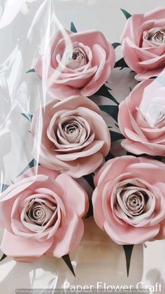 pink flowers are in a vase on the table