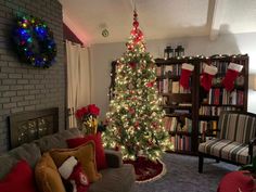 a living room with a christmas tree in the corner