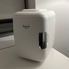 a white toaster sitting on top of a counter