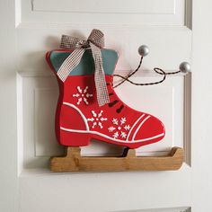 a pair of red boots hanging on the front door