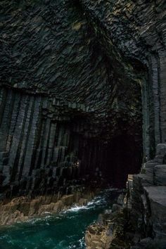 the entrance to an underground cave with water running through it