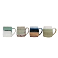 four different colored mugs sitting next to each other