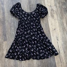 Black With Pretty Purple Flowers Brand New Has Tags... Nothing Is Wrong With It Xs But Fits Me Size Small If You Have A Bigger Chest, It May-Be A Little Tight Cute Black Mini Dress With Short Sleeves, Casual Purple Floral Dress For Spring, Black Summer Dress With Ditsy Floral Print, Black Ditsy Floral Print Dress For Summer, Black Ditsy Floral Dress For Summer, Casual Purple Floral Dress For Summer, Black Floral Short Sleeve Beach Dress, Black Floral Short Sleeve Dress For Beach, Flowy Black Floral Print Dress