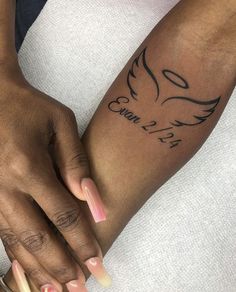 a woman's arm with a bird tattoo on it and the word love is written in cursive font