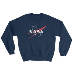 NASA 'VECTOR LOGO' SWEATSHIRT The NASA 'Vector Logo' Sweat Shirt! Now in Black and Navy Blue The NASA logo dates from 1959. After a NASA Lewis Research Center illustrator's design was chosen for the new agency's official seal, the executive secretary of NASA asked James Modarelli, to design a logo that could be used for less formal purposes. Modarelli simplified the seal, leaving only the white stars and orbital path on a round field of blue with a red vector. Then he added white N-A-S-A letteri Astronaut Suit, Astronaut Costume, Nasa Shirt, Nasa Logo, Popular Logos, Space Shirts, Research Center, Love And Pride, Clothing Patches