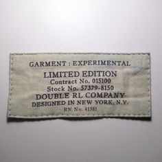 the label is on top of a piece of cloth that says, garment experiment limited edition contact no 019900