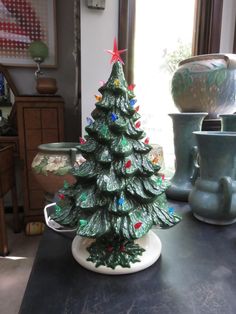 a ceramic christmas tree sitting on top of a table