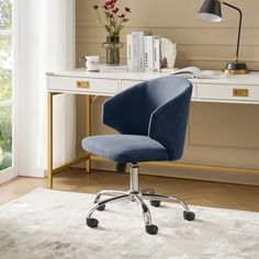 a blue office chair sitting in front of a desk with a lamp on top of it