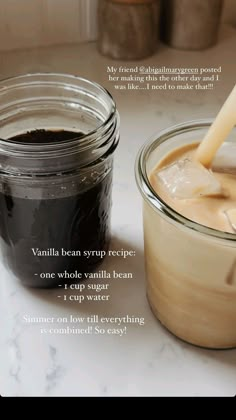 a jar filled with liquid sitting on top of a counter next to a glass container