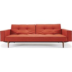 an orange couch with two pillows on it's back and one arm folded open