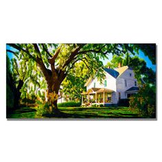 a large white house sitting under a tree in the middle of a green field with lots of trees