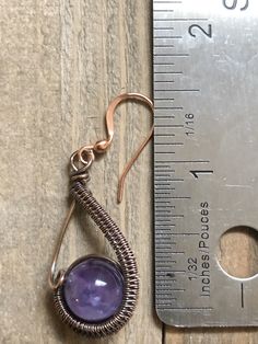 Copper wire has been carefully woven around a 10mm Amethyst bead to make these cute drop earrings and then suspended from a copper ear wire. The drop is approx. 1 inch in length. These earrings were inspired by Cheryl St. Pierre. Artisan Purple Earrings With Ear Wire, Purple Artisan Earrings With Ear Wire, Hand Wrapped Copper Wire Earrings For Gifts, Hand Wrapped Drop Earrings, Hand Wrapped Drop Earrings As Gift, Hand-wrapped Drop Earrings For Gifts, Hand Wrapped Drop Earrings For Gift, Hand-wrapped Drop Earrings Gift, Wire Wrapped Amethyst Round Earrings