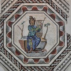 a mosaic with a woman holding a harp