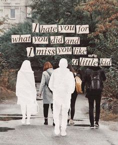 three people walking down a sidewalk with signs on the side of them that say i hate you for what you did and miss you like at the entire kid