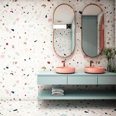 a bathroom with two sinks and mirrors on the wall