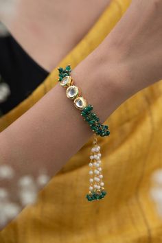 22k gold plated, silver alloy bracelet with green onyx, kundan embellishmemt and tassel bead drops. - Aza Fashions Fabric Kundan Jewelry, Fancy Rakhi Design, Handmade Kundan Bracelets, Kundan Bracelet Design, Rakhee Designs, Kundan Rakhi, Rakhi Hampers, Kundan Bracelet