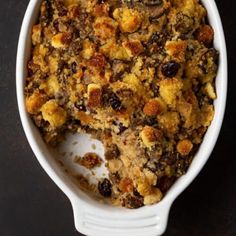 a casserole dish filled with stuffing and raisins