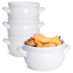 a white bowl filled with food next to three stacked bowls on top of each other