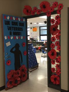 a door decorated with red poppies and the words we give our veterans a hand