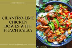 a blue bowl filled with chicken, rice and veggies on top of a wooden table