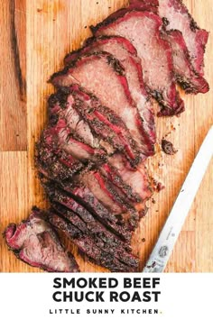 sliced beef on a cutting board next to a knife with the words smoked beef chuck roast