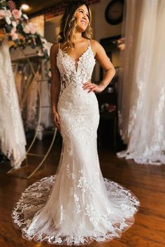 a woman in a wedding dress posing for the camera