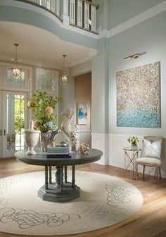 a living room filled with furniture and flowers in vases on top of a table