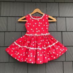 "Sweet and cute true vintage well-loved little girls cotton dress is hand made in bright tomato red with varied polka dots in blue and white. White novelty trim at neckline and waist. Button closure at center back.  Clearly hand made with all the authentic details you would expect: hand finished buttonholes, full gathered skirt. Shows the usual signs of love and wear, hem is undone. Bust 24\" Waist 23\" Hip open Length from shoulder to waist 10\" Skirt length from waist 12\"" 1950s Style Lined Cotton Dress, Red 1950s Spring Dresses, Cute Cotton Swiss Dot Dresses, Cute Swiss Dot Cotton Dress, Cute Polka Dot Cotton Dress, Red Cotton Vintage Summer Dress, Fitted Retro Swiss Dot Dress, Red Cotton Vintage Dress, Retro Fitted Swiss Dot Dress