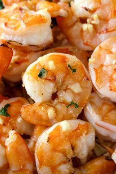 closeup of cooked shrimp with parsley and garlic on the top, ready to be eaten