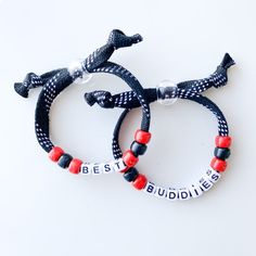 two bracelets that say best buddies and one has an elephant on it with red beads