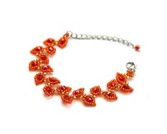 an orange beaded bracelet on a silver chain